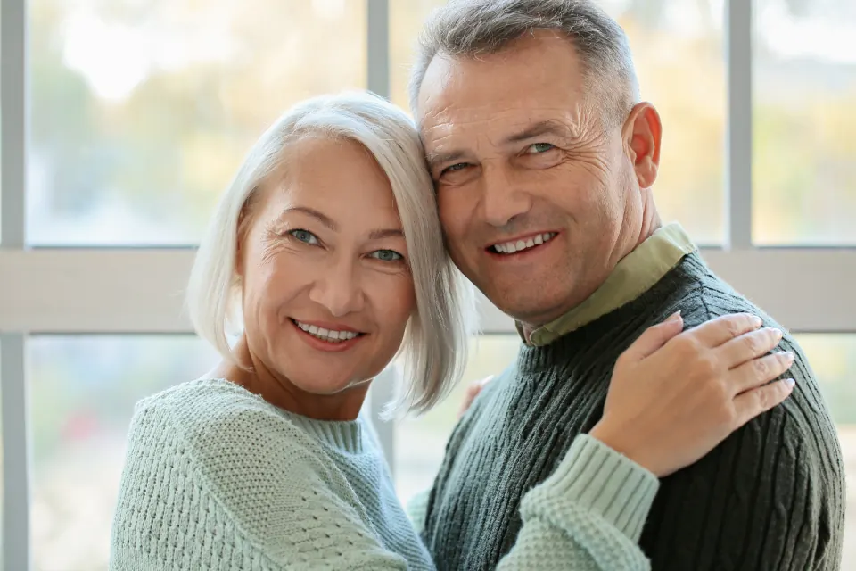 An older couple smiling together at home